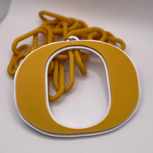 Gold letter 'O' pendant on a chain against a white background