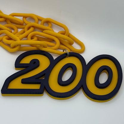 Yellow and black '200' keychain on a white background